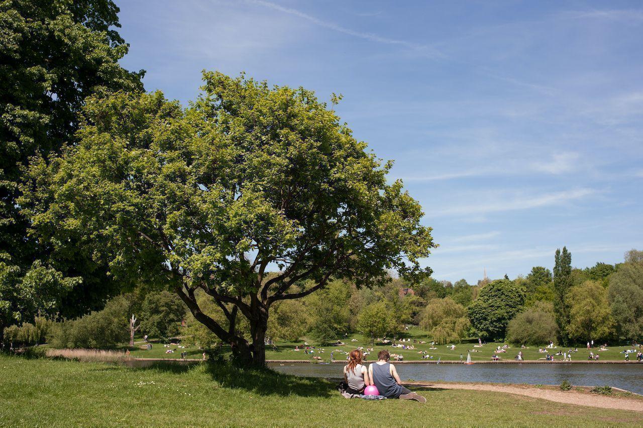 Couple relaxing on the grass in Hampstead Heath